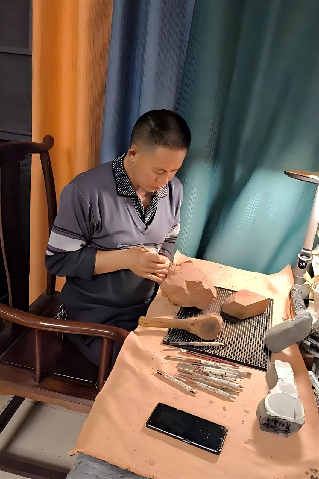 Artisan carving a stone artwork by hand